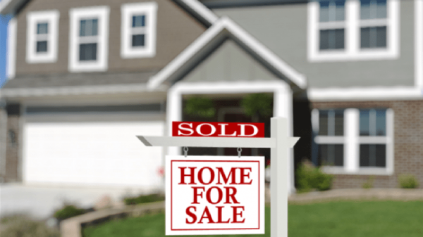 Home with a Home for sale, Sold sign on the front lawn.